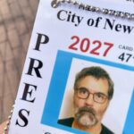 photo of the corner of a City of New York press card for Greg Pak featuring his mugshot, the word PRESS and the date 2027.